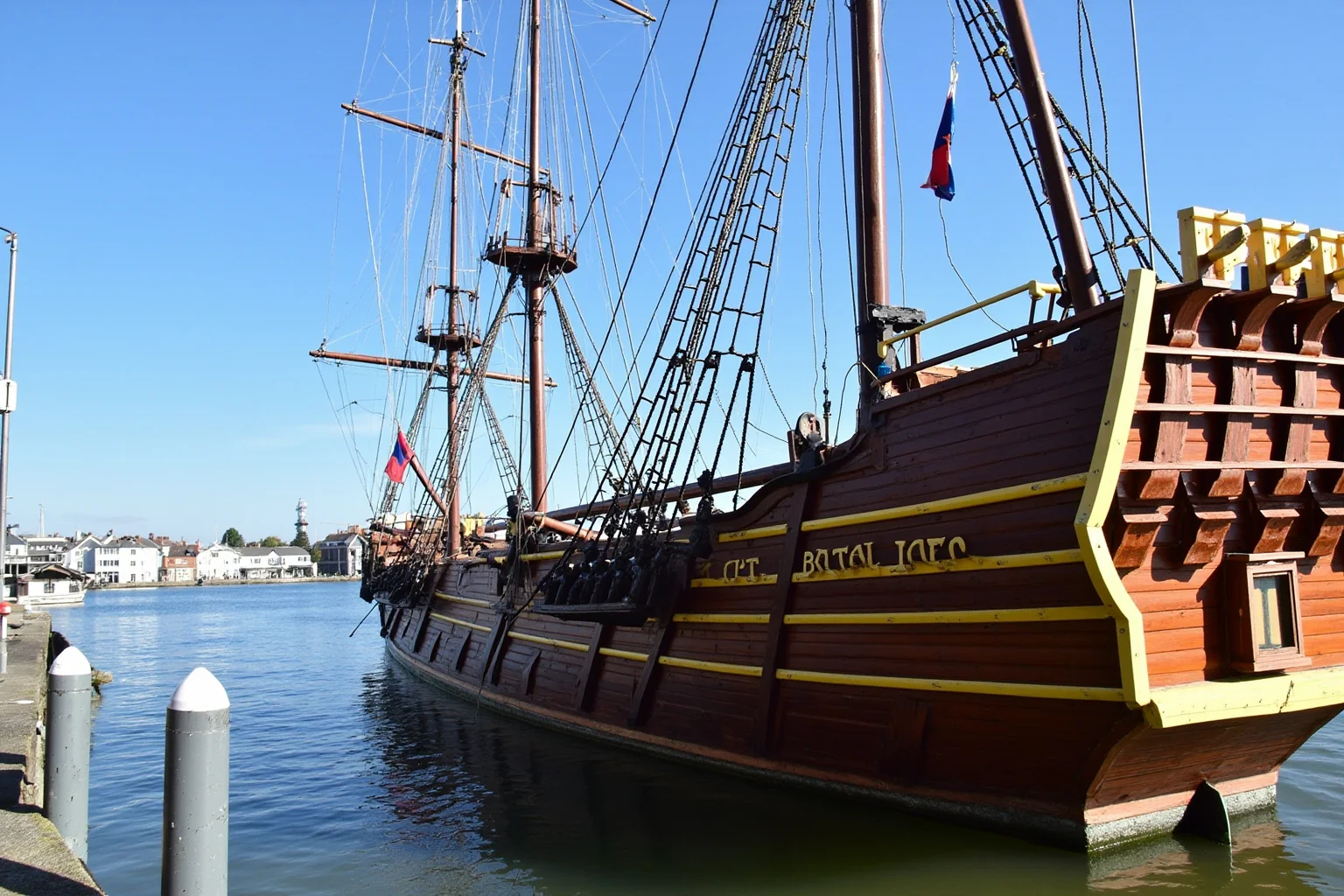 The Longest-Serving Warships of All Time 5 Wooden 19th-century Royal Navy frigate built from dark teak wood, preserved as a museum ship at a quiet dockside