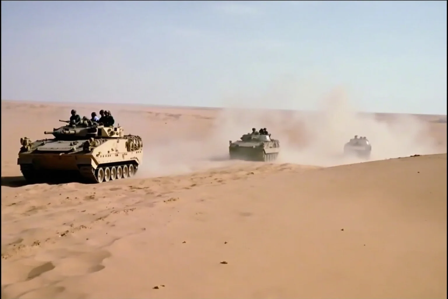 1990s coalition armored vehicles advancing across desert, dust plumes, wide cinematic shot, no insignia