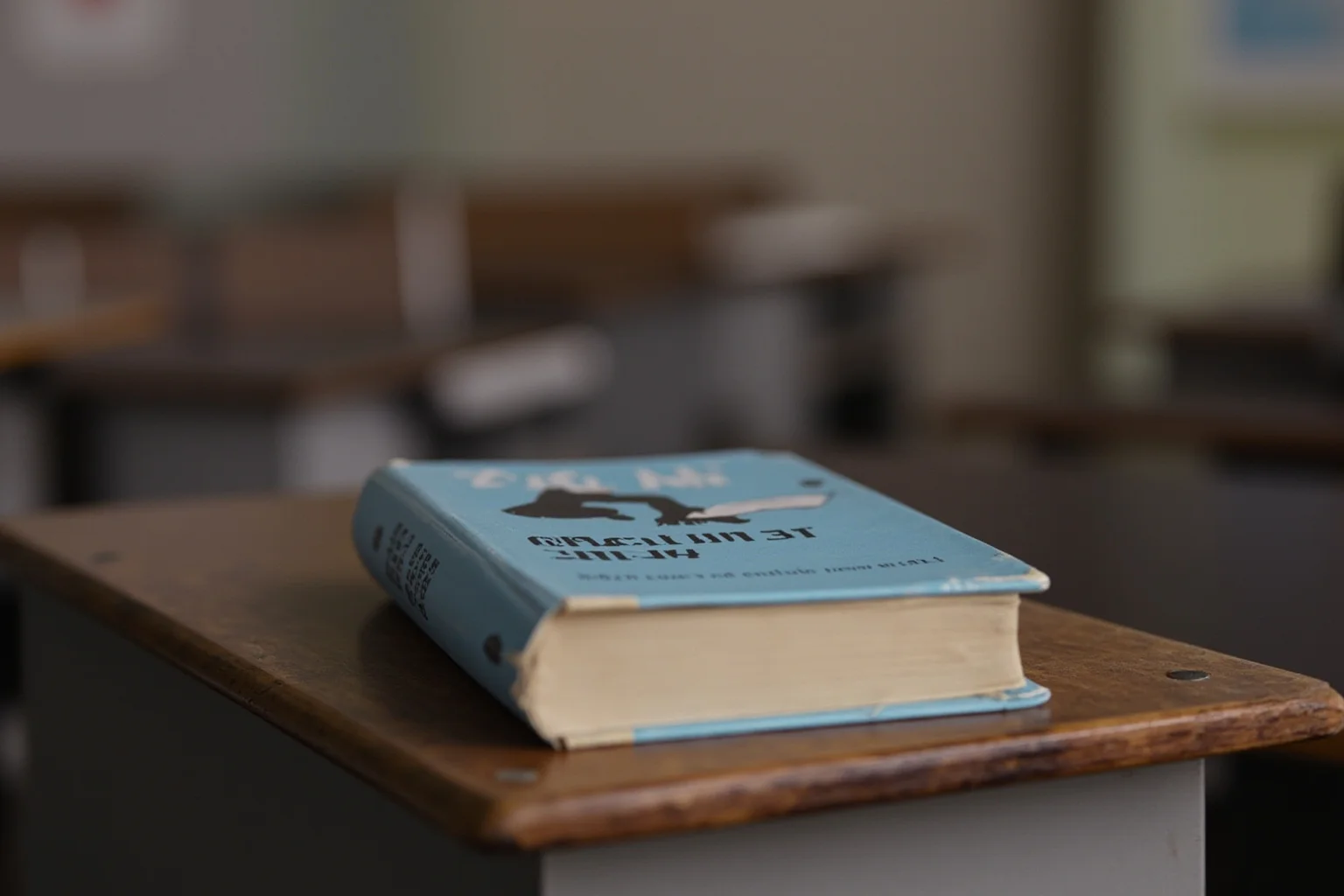 A 1961 hardcover copy of Black Like Me on a classroom desk, vintage educational setting, no people.