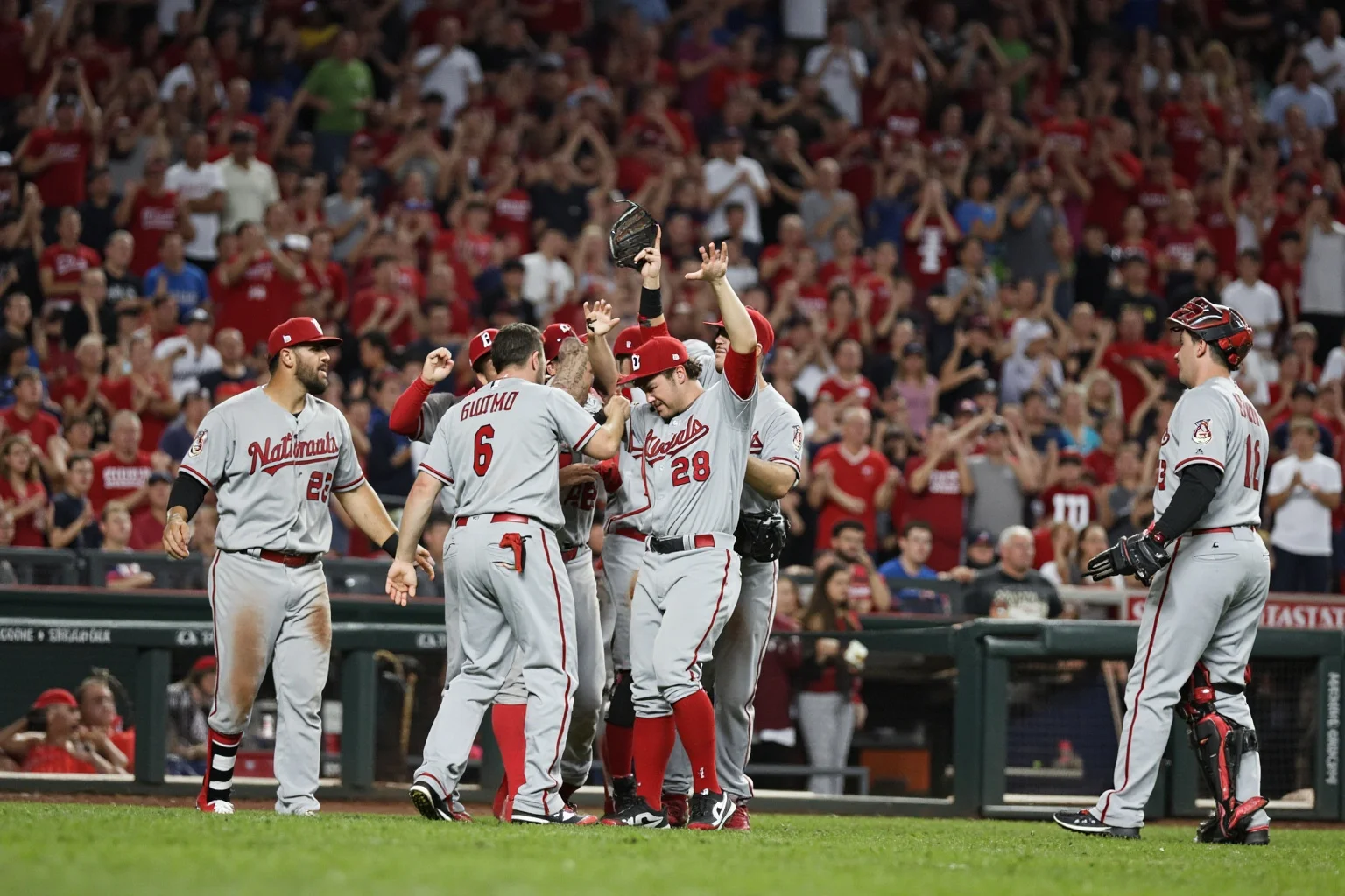 25 Memorable Moments That Defined World Series History 24 A 2019 Nationals-style road team celebration in a Houston-style ballpark, players in gray road uniforms, no recognizable faces.