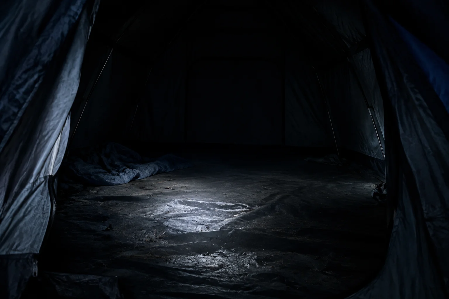 The Horrifying Camp Scott Incident That Still Haunts Oklahoma 14 A dark, empty tent interior, evoking the crime scene.