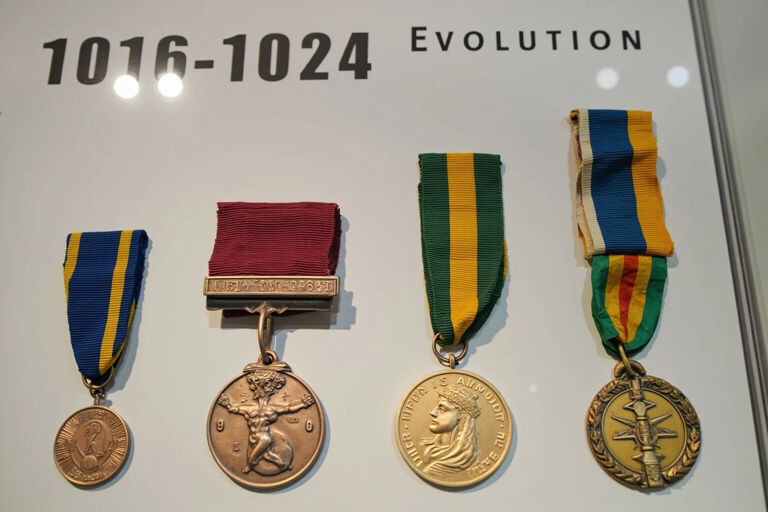 The Weird History of Olympic Medal Designs 18 A display of Olympic medals from different eras side by side, showing design evolution.