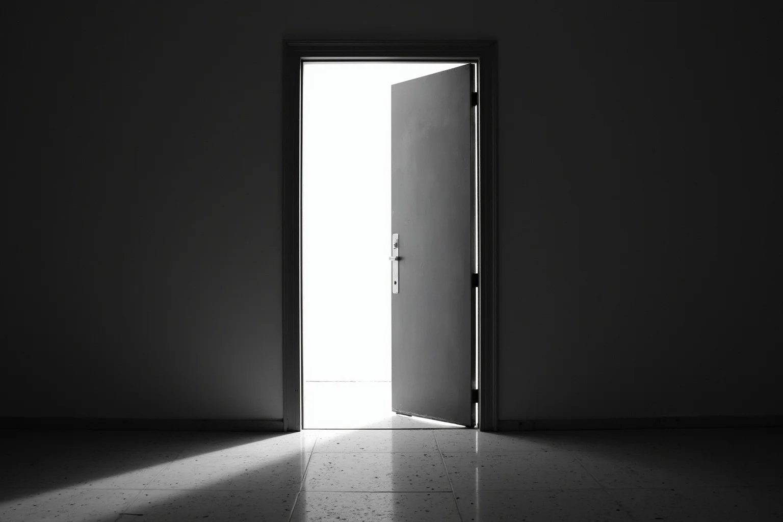 A divided doorway with one side bright and one side shadowed, symbolizing reversible privilege, no person.
