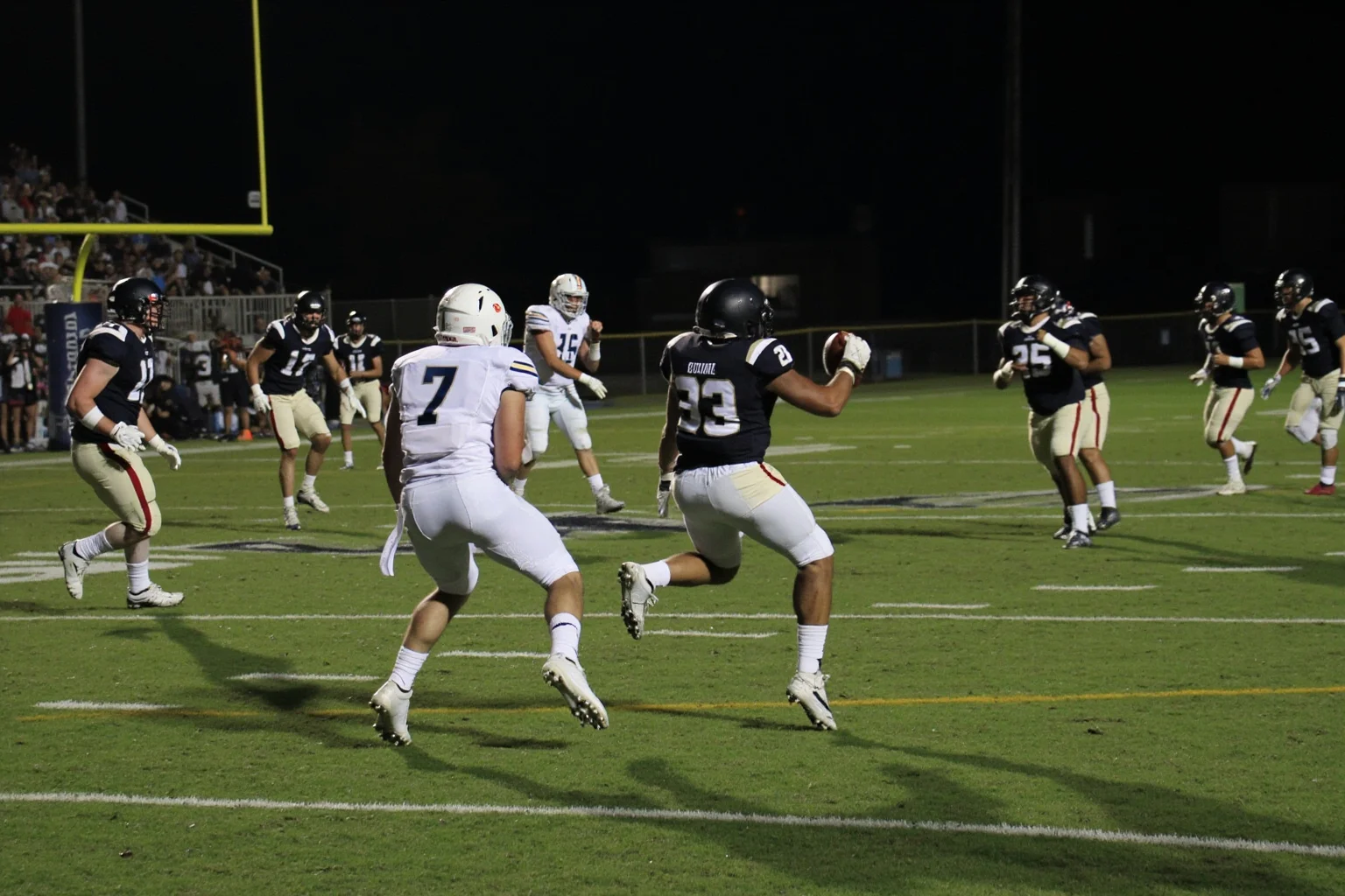A field goal attempt splitting the uprights as time expires, generic uniforms, no real logos or names, night stadium.