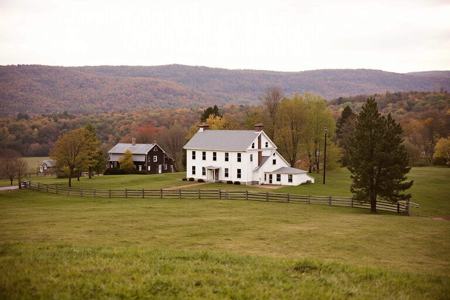 Old Money: 24 Hidden Dynasties That Shaped the Course of History 15 A Hudson Valley patroon manor house above a tenant farm in autumn, split-rail fences and rolling fields, soft overcast light, no people, landscape photography.