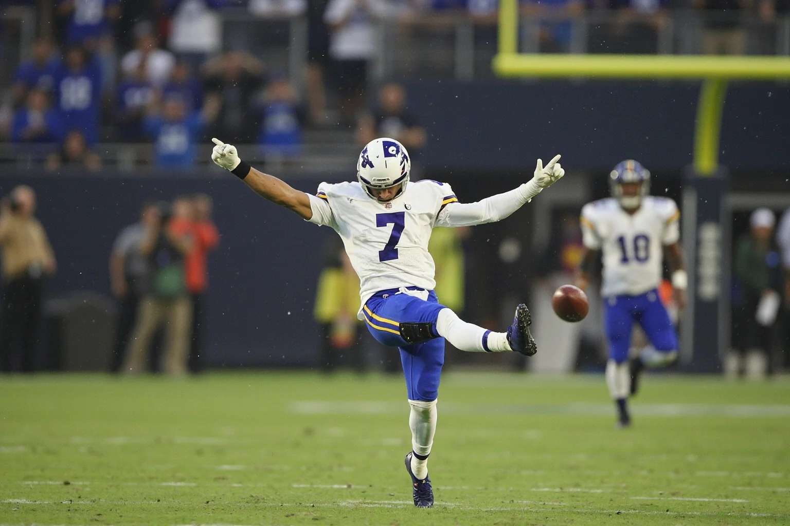A kicker celebrating a game-winning field goal in the rain, generic uniform, no real logos or names, emotional moment.