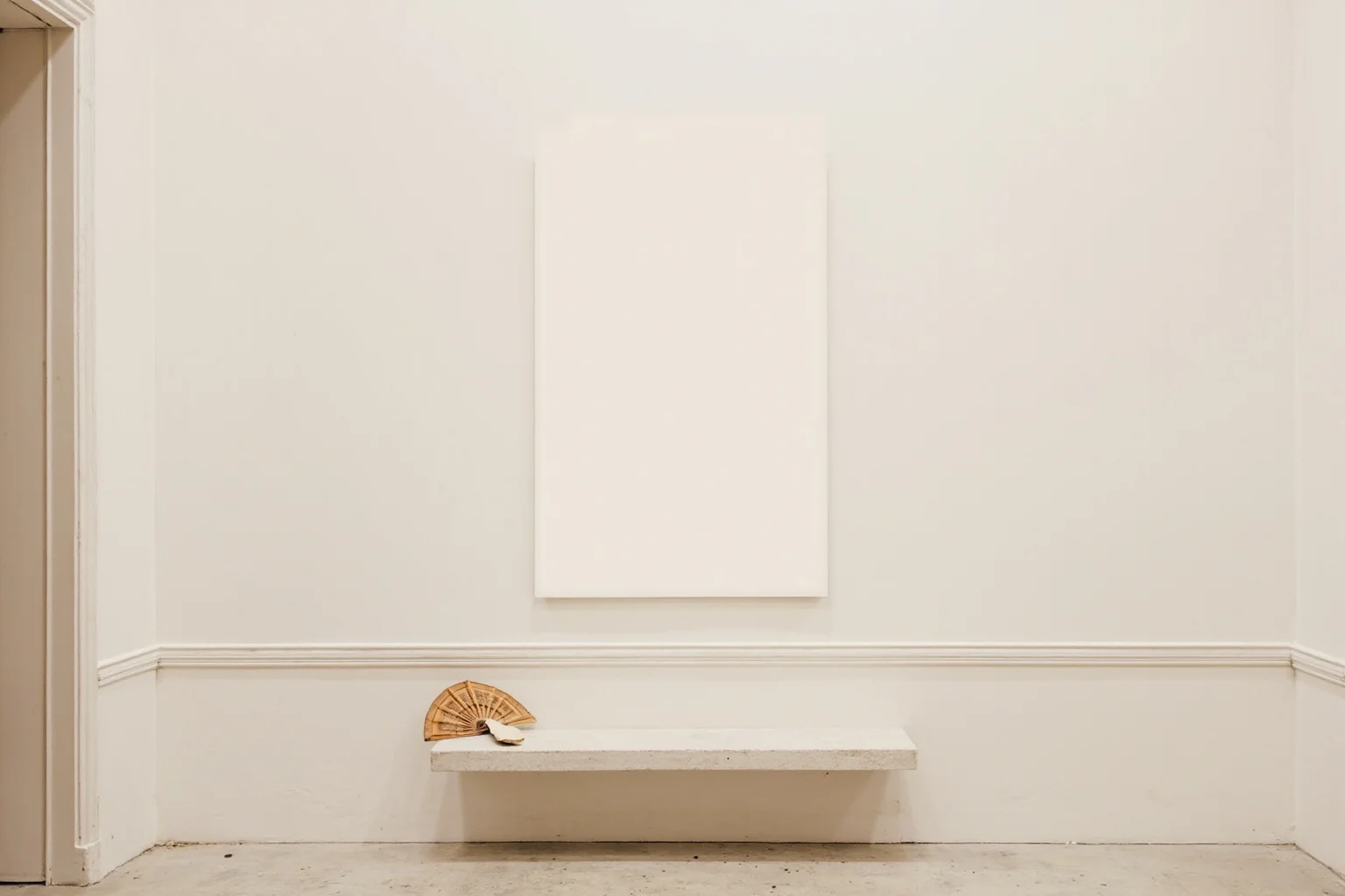 22 Famous Paintings That Were Stolen — Including 10 That Were Never Recovered 22 A pale portrait-shaped blank space on an elegant Paris gallery wall with a folded fan left on a nearby bench, soft neutral light, painterly style.