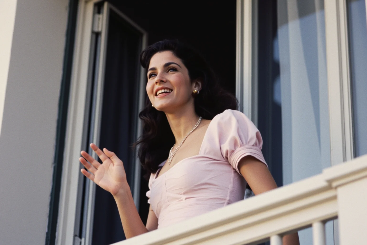 Things To Learn About The Beloved Princess Diana 7 A young woman in an elegant 1980s dress waving from a balcony, viewed from a distance, face not visible, soft daylight, no recognizable public figures.