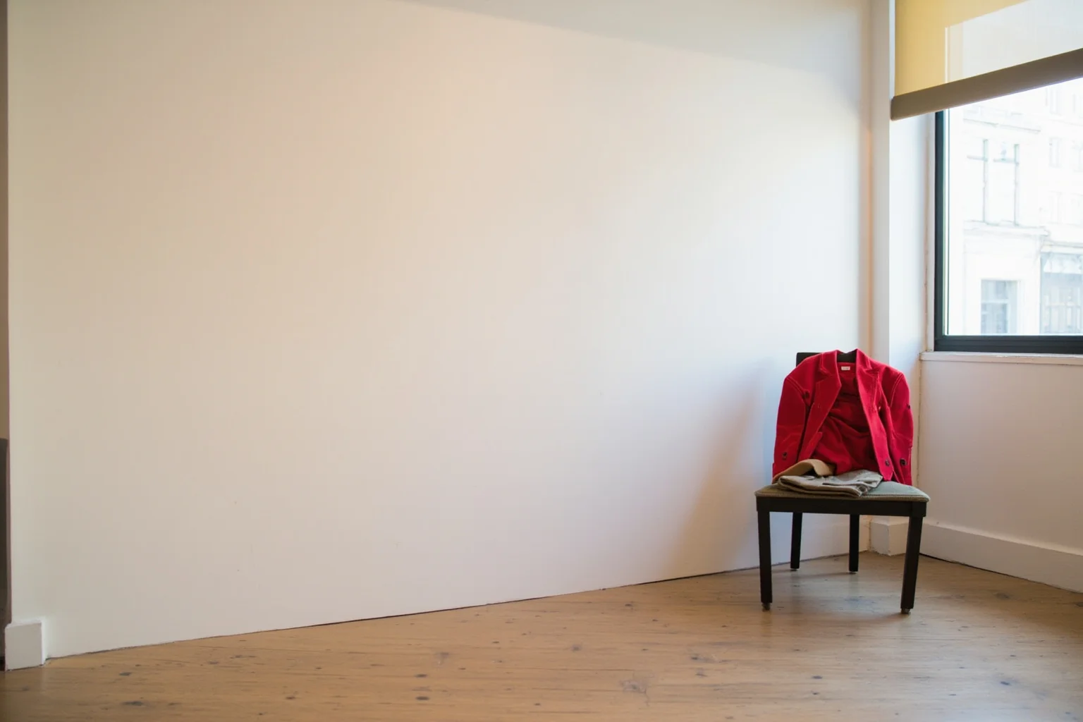 22 Famous Paintings That Were Stolen — Including 10 That Were Never Recovered 10 A Zurich museum room with a blank wall and a red waistcoat draped over a chair nearby, sunlight through window blinds, painterly style.