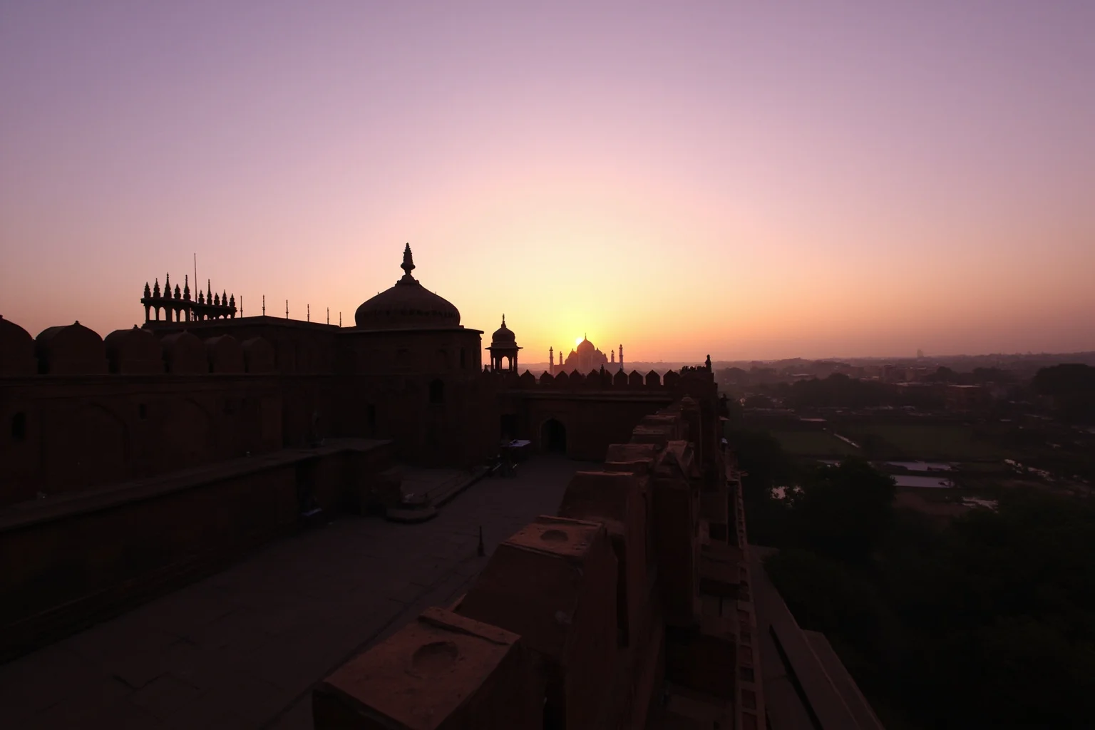 Agra Fort at sunset with a distant view of the Taj Mahal