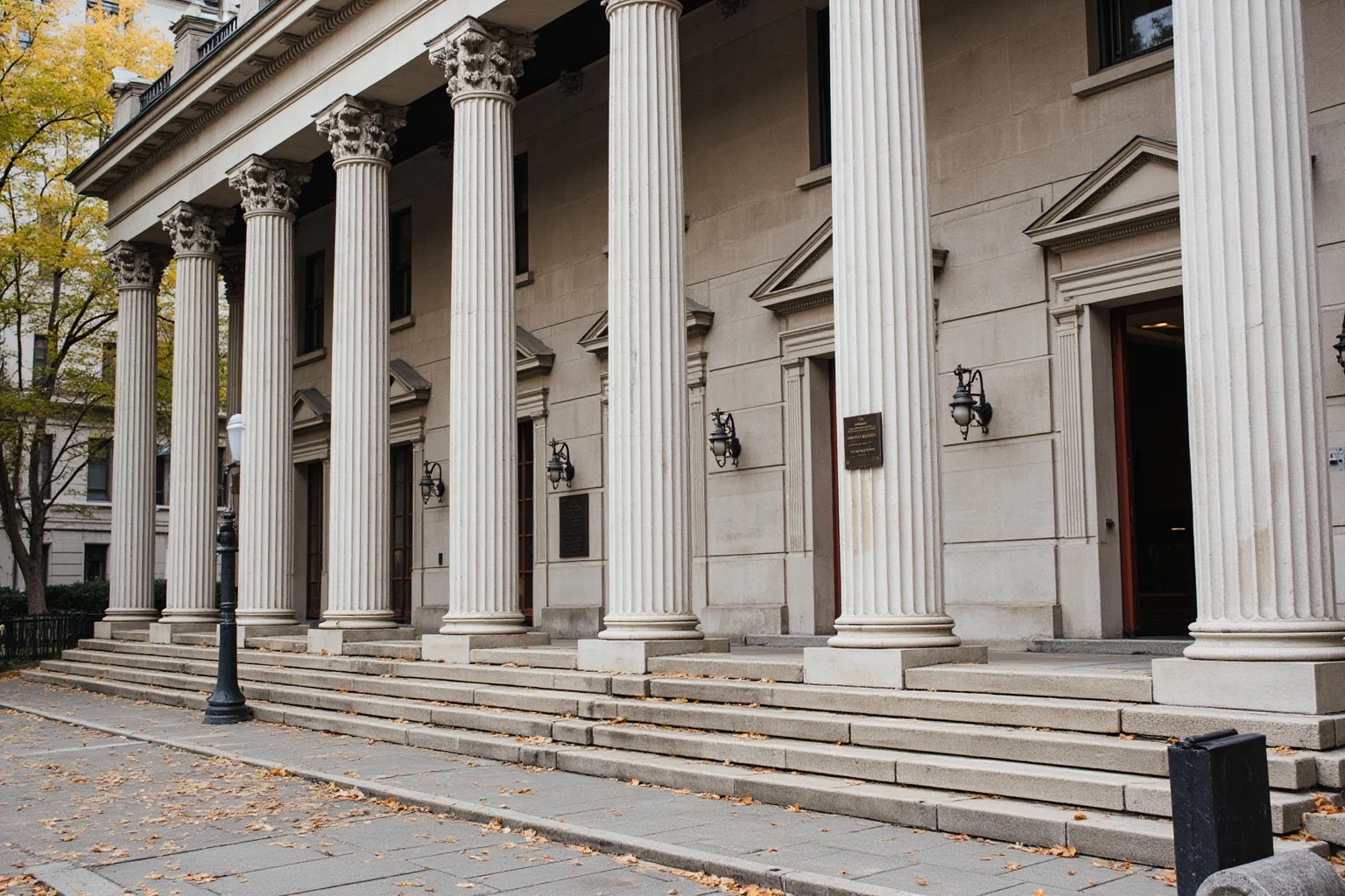 Old Money: 24 Hidden Dynasties That Shaped the Course of History 17 An 1830s Philadelphia Greek Revival bank building with tall columns and a bronze plaque, autumn leaves on the steps, no people, architectural photography.