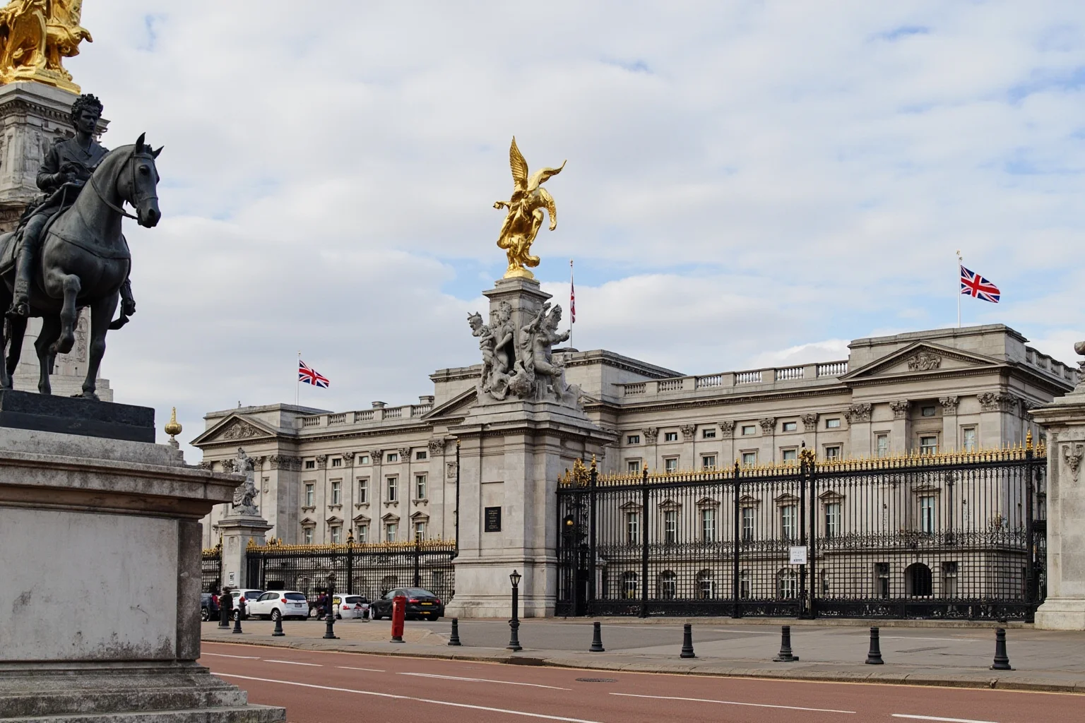 Buckingham Palace with modern British royal symbolism and Union Jack flags