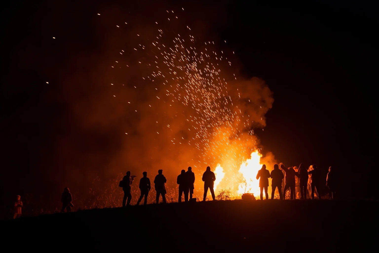 Communal bonfire on a hill at night with silhouettes of people gathered, sparks rising, autumn harvest festival atmosphere, no text