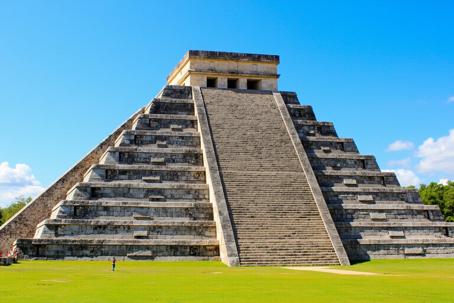 22 Most Famous Pyramids in the World 10 El Castillo at Chichen Itza with its four stairways and green lawn in the foreground, no close-up of people.