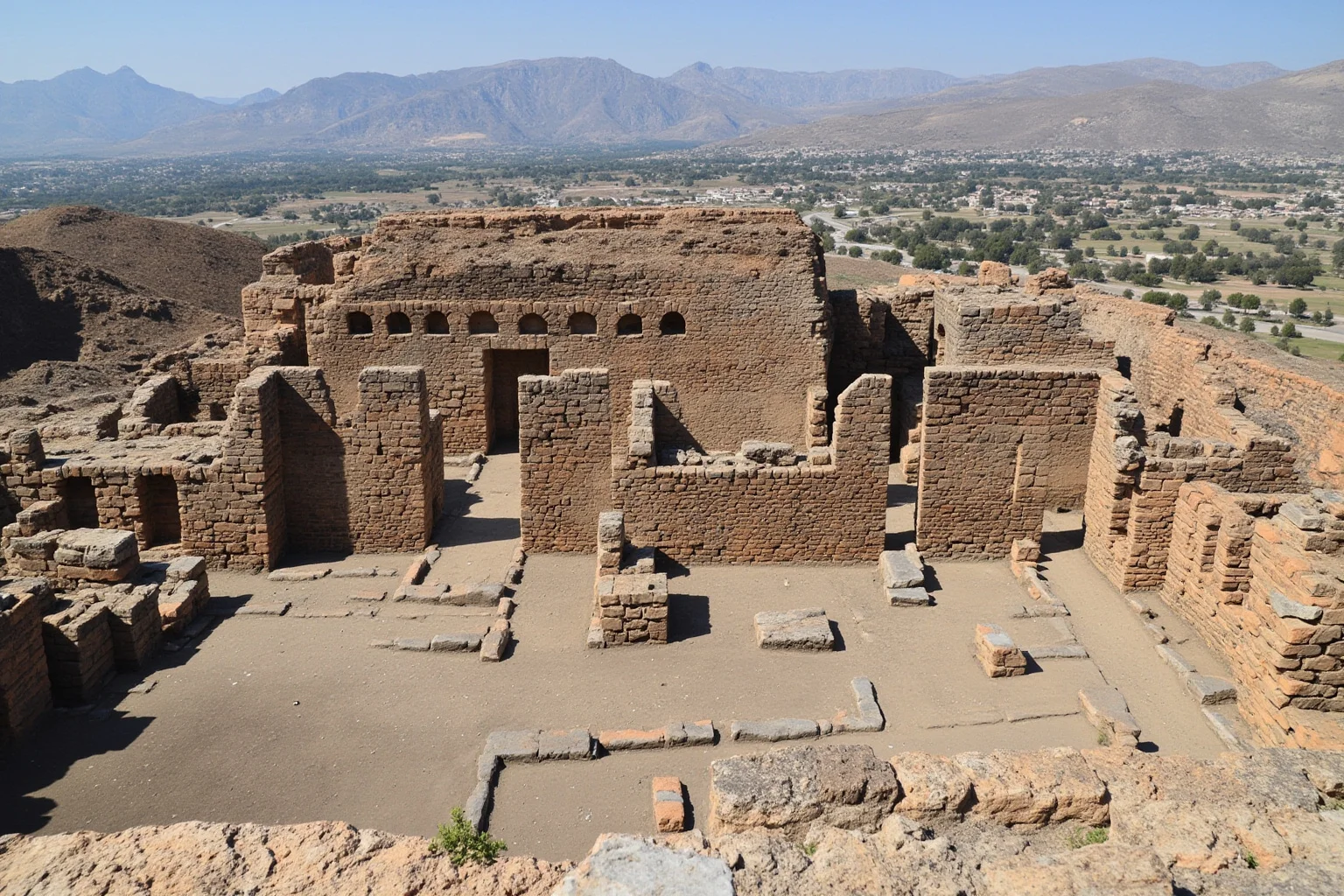 The Fertile Crescent: 20 Ancient Civilizations That Started Society As We Know It 7 Hittite capital Hattusa with massive stone gates and chariots, rugged Anatolian landscape in the background.