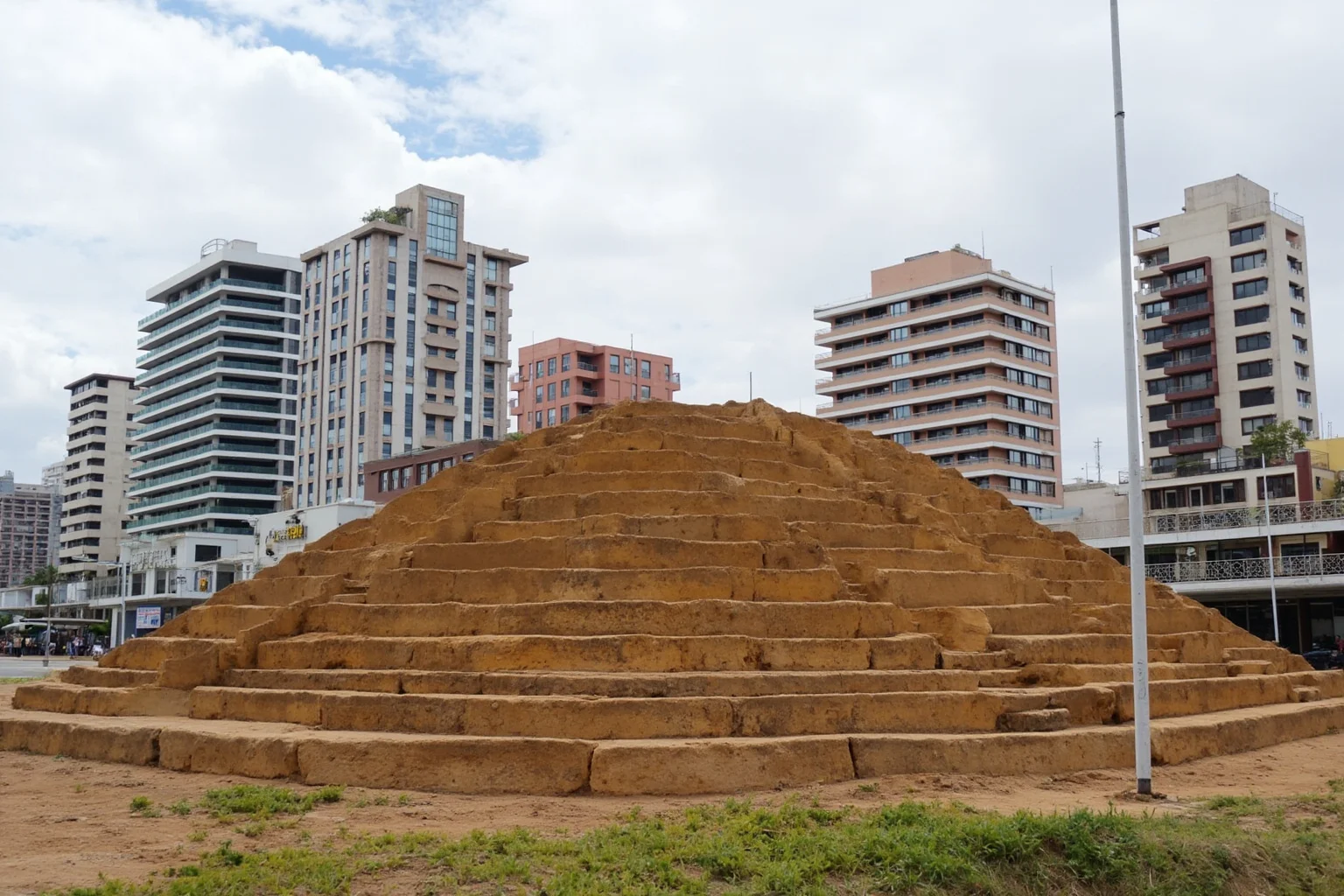 22 Most Famous Pyramids in the World 18 Huaca Pucllana in Lima, Peru, a stepped adobe pyramid surrounded by modern city buildings.