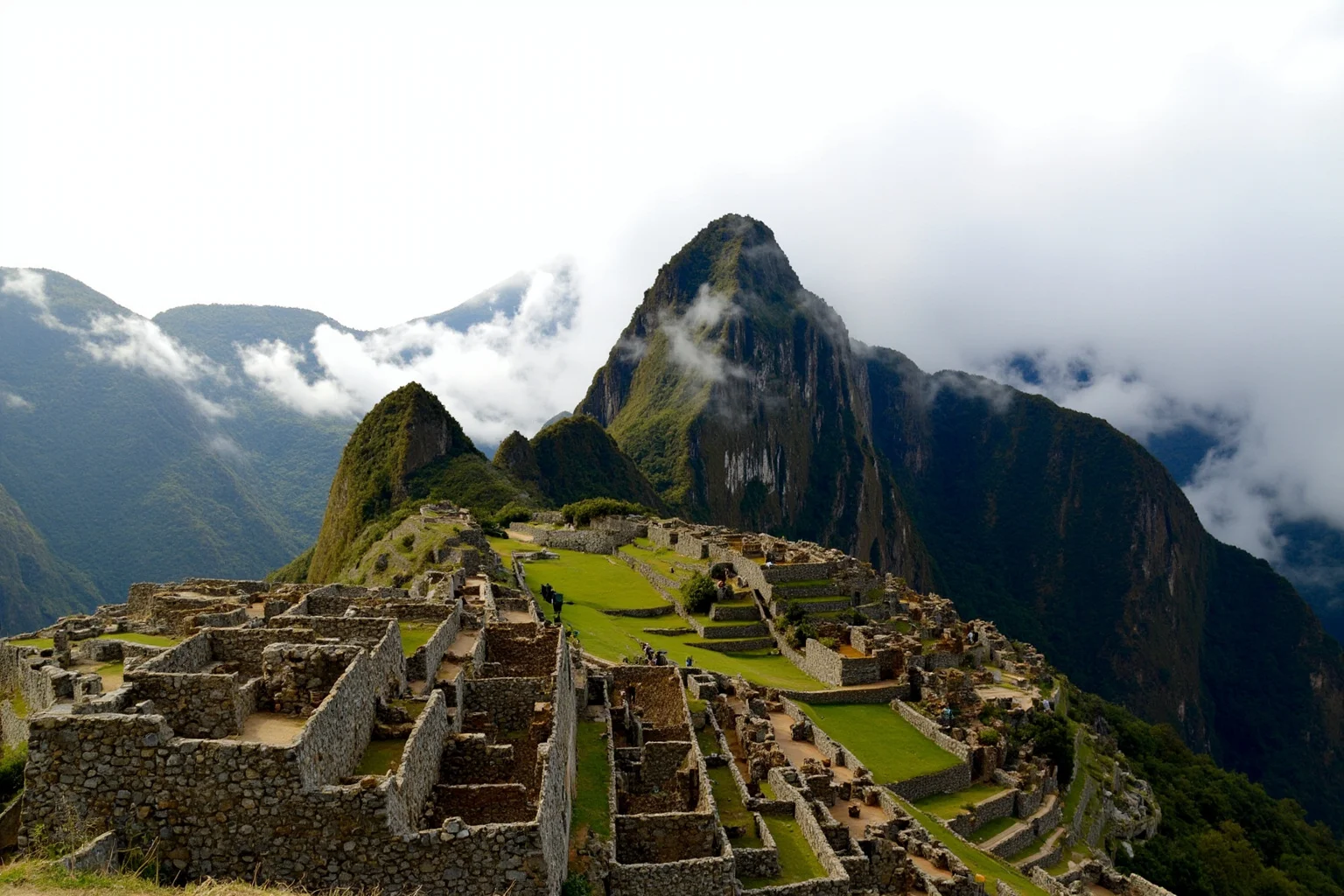 Machu Picchu's stone terraces and Huayna Picchu peak in morning cloud, Peru