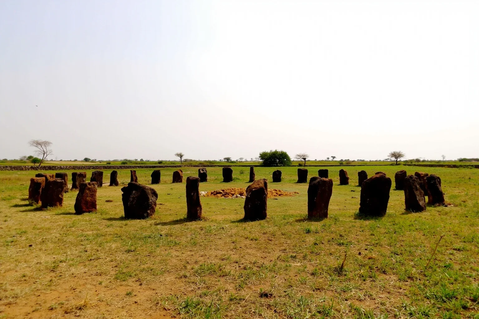 22 Oldest Monuments Found Around the World 23 Megalithic stone circles of Senegambia in West Africa, showing laterite stone pillars arranged in a circular pattern in a grassy field