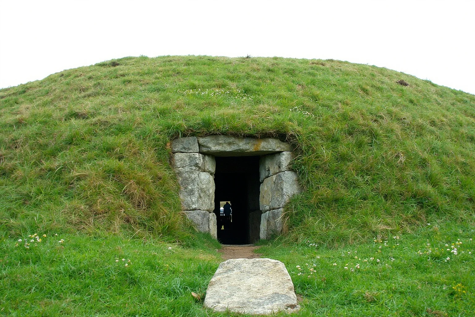 22 Oldest Monuments Found Around the World 10 Neolithic passage tomb of Newgrange in Ireland, showing the grass-covered mound and decorated entrance stone