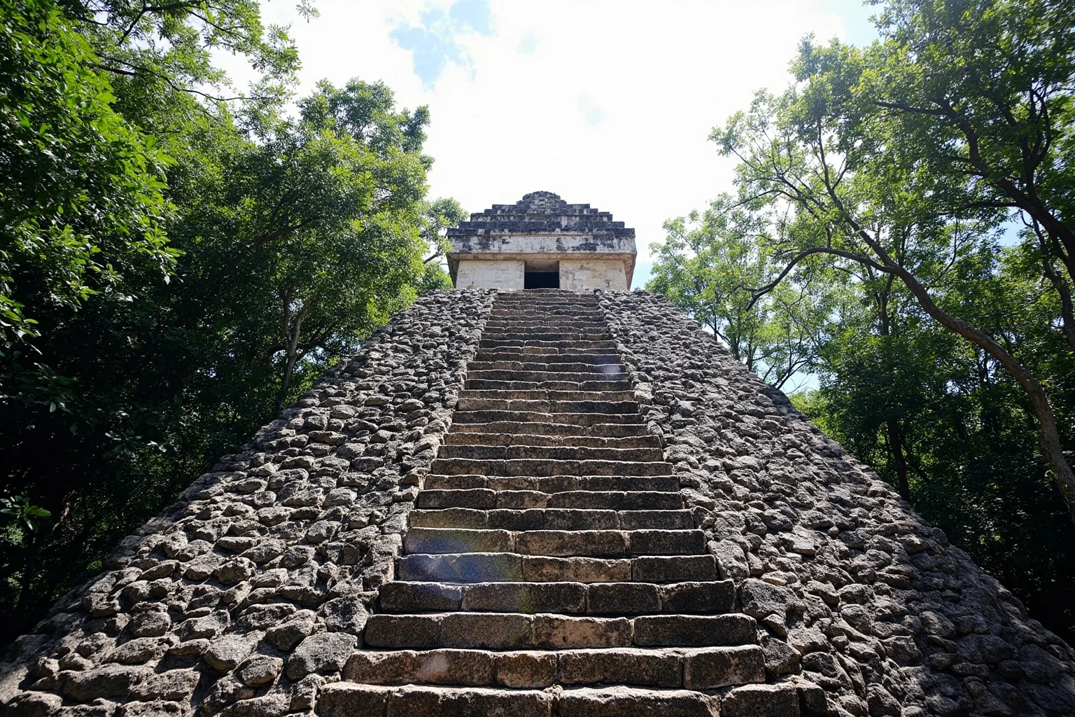 22 Most Famous Pyramids in the World 13 Nohoch Mul pyramid at Coba rising above the jungle canopy with stone steps climbing the front.