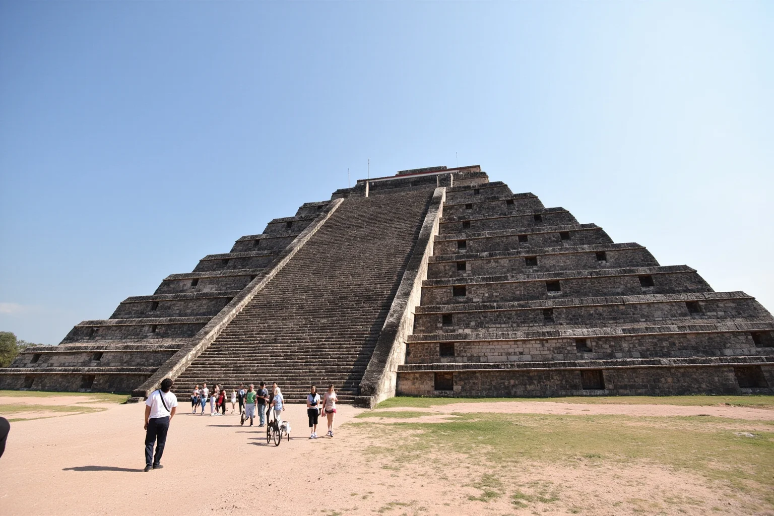22 Most Famous Pyramids in the World 8 Pyramid of the Sun at Teotihuacan along the Avenue of the Dead, with people walking at the base for scale.