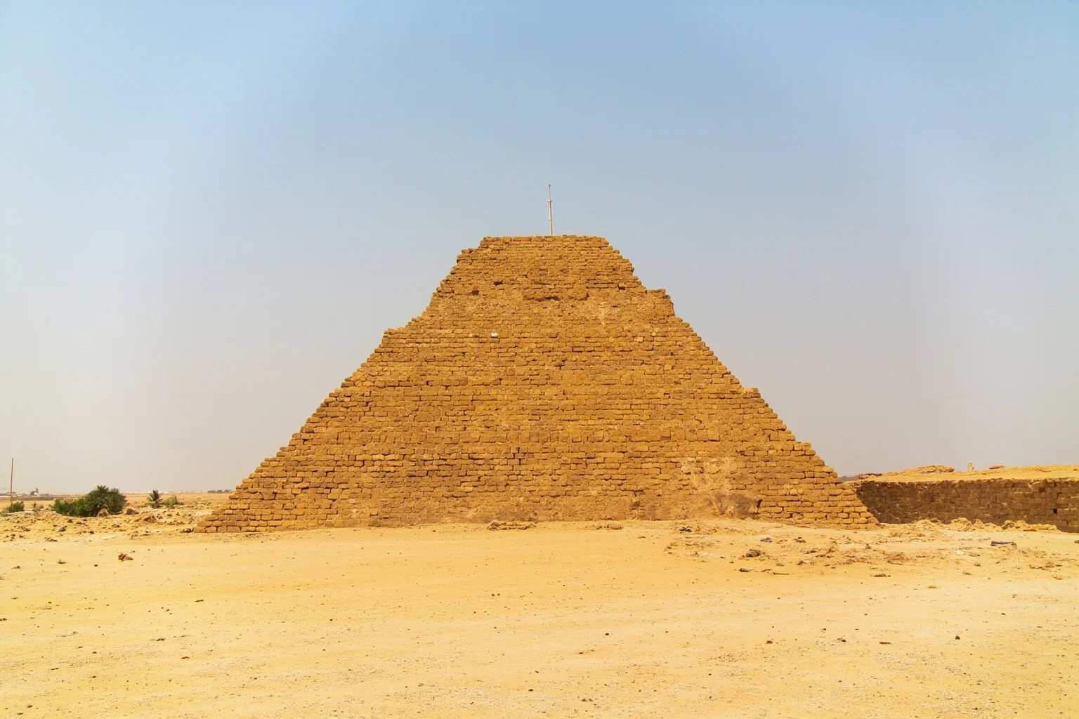 22 Most Famous Pyramids in the World 5 Step Pyramid of Djoser at Saqqara, showing six stone tiers and the surrounding desert enclosure.