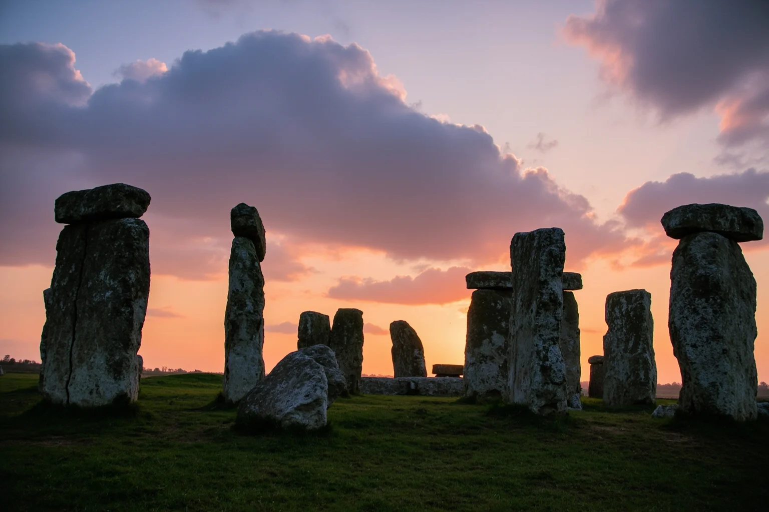 22 Oldest Monuments Found Around the World 14 Stonehenge stone circle on Salisbury Plain at sunrise, showing sarsen stones with lintels and surrounding landscape