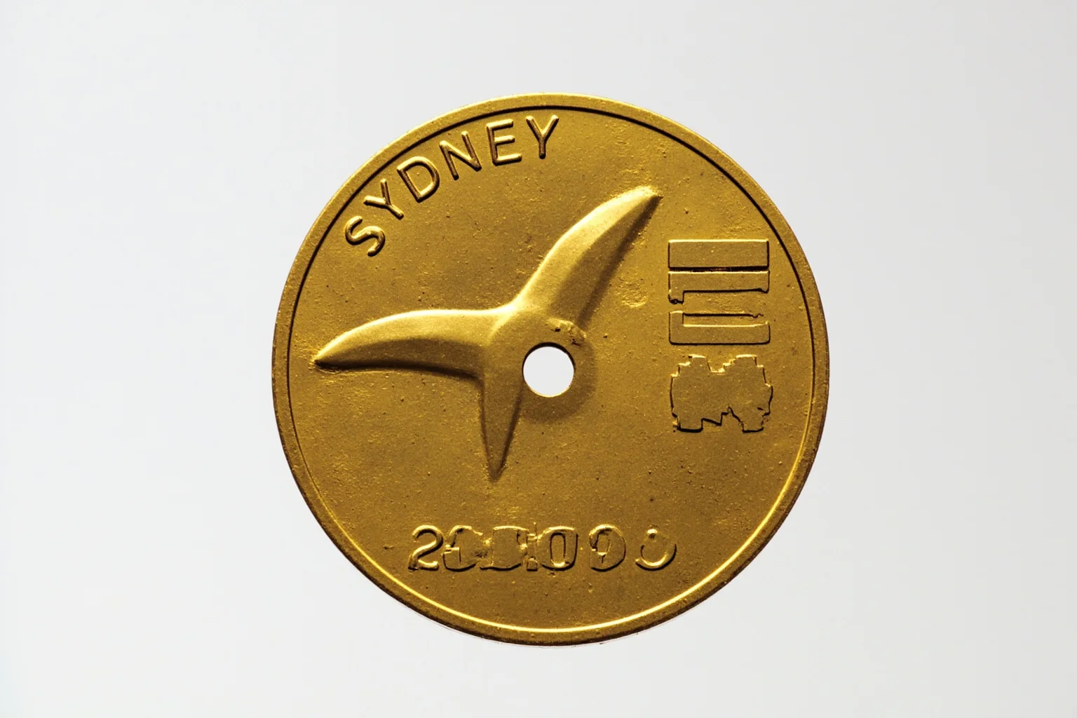 The Weird History of Olympic Medal Designs 11 The 2000 Sydney Olympic medal with a hole in the center and boomerang-inspired shape.