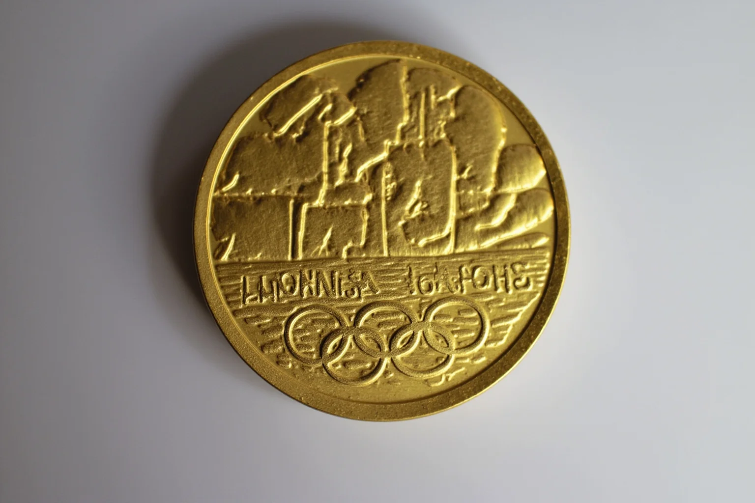 The Weird History of Olympic Medal Designs 14 The 2012 London Olympic medal with a textured surface and River Thames motif.