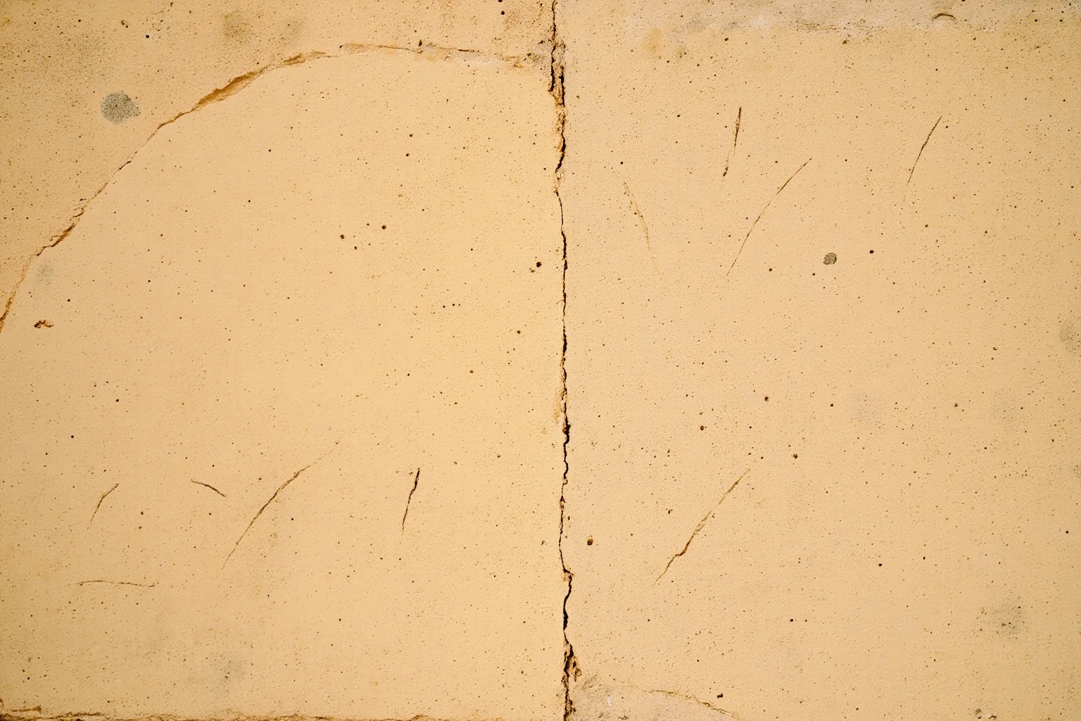 23 Ancient Graffiti Messages That Sound Shockingly Modern 5 Two sets of scratches side by side on a Roman plaster wall as if in conversation, warm side light, weathered texture, no people.