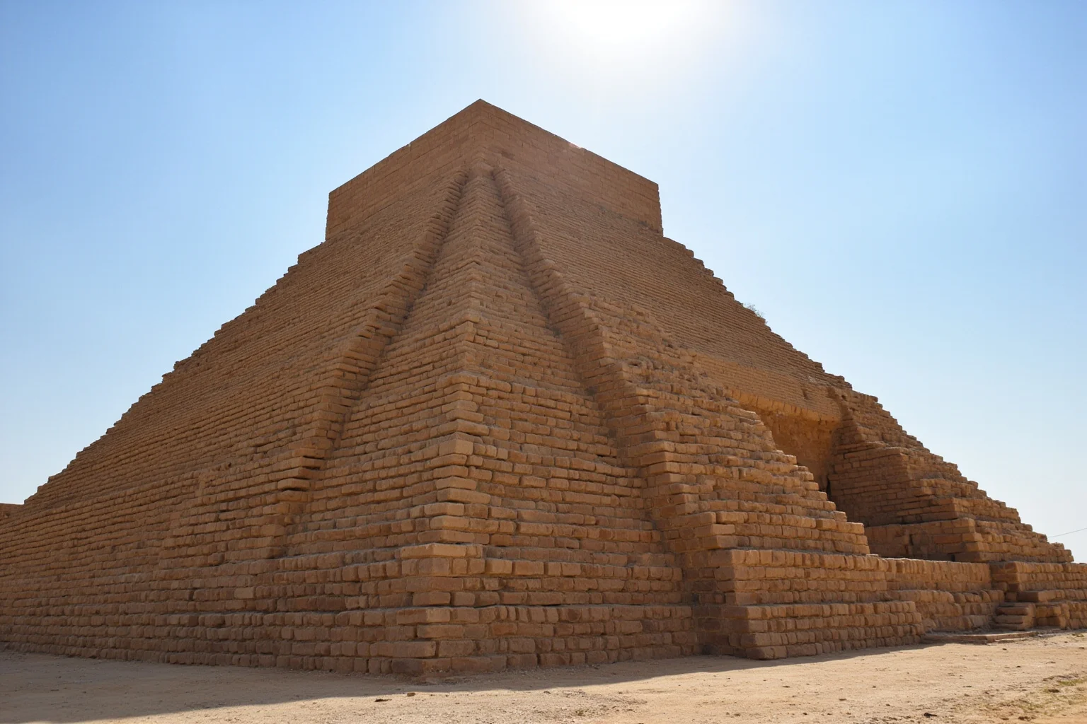 22 Oldest Monuments Found Around the World 20 Ziggurat of Ur in Iraq, showing reconstructed stepped temple with mud-brick walls under a bright sky